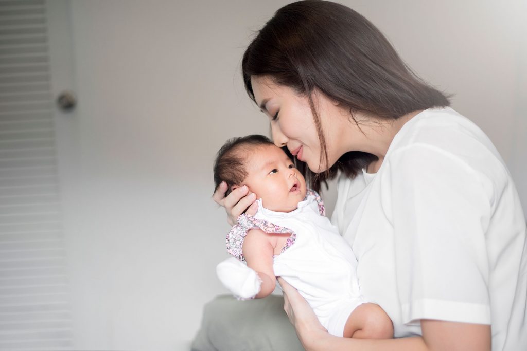 A Mother Holding Newborn Child in Confinement Centre